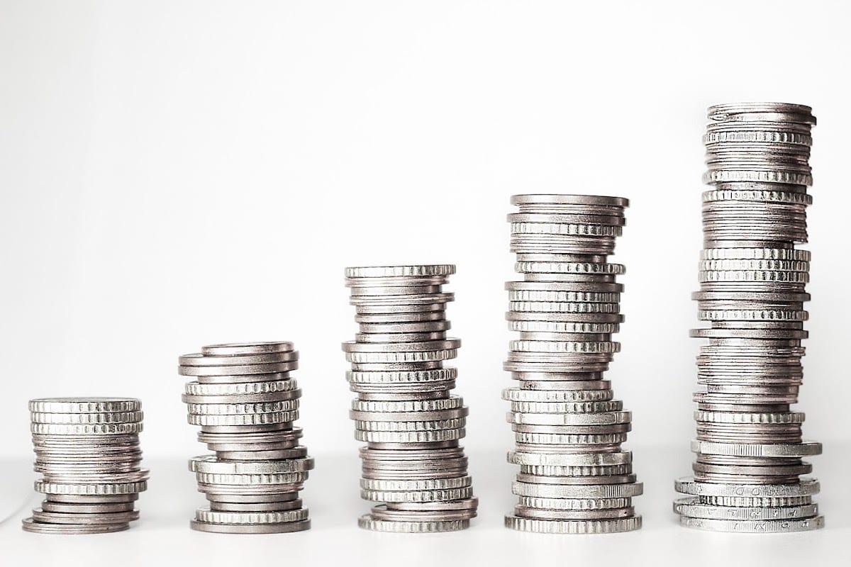An image of five stacks of silver coins.