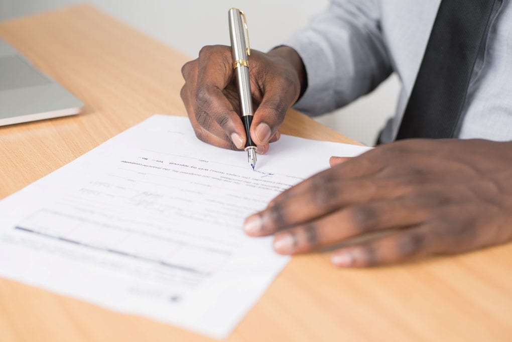 person writing with fountain pen