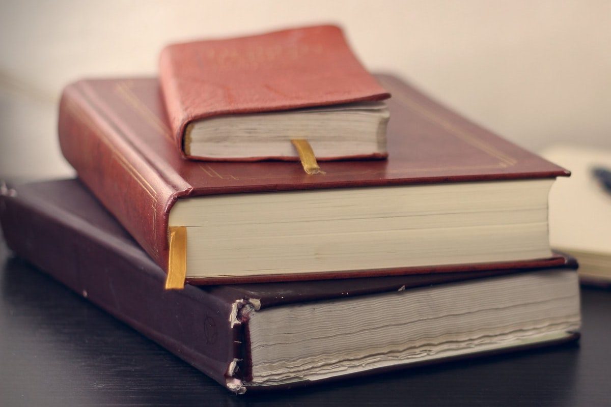 Three stacked books. Law Studies Master's Degrees