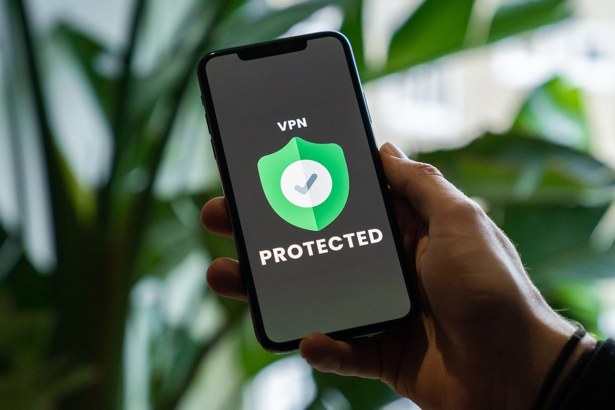 Hand holding a mobile device displaying VPN security protection. Security Analyst Tools